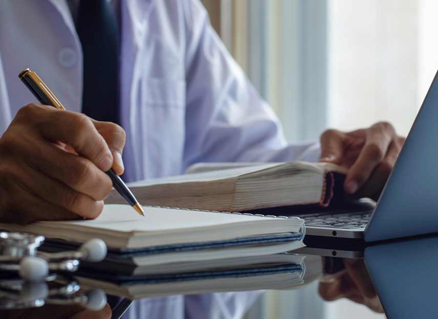 doctor writing on notebook